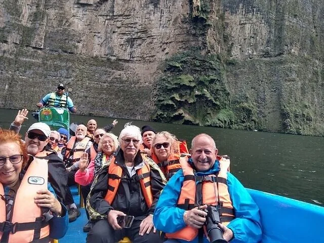 Group of tourists on a boat tour in Sumidero Canyon wearing life jackets