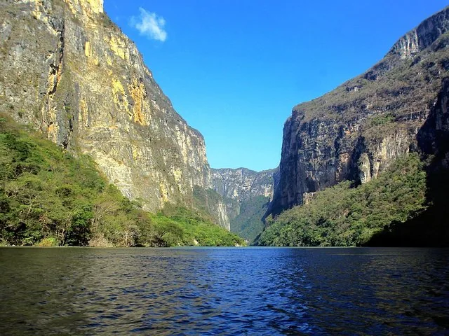 View of the Sumidero Canyon with towering cliffs and a river.