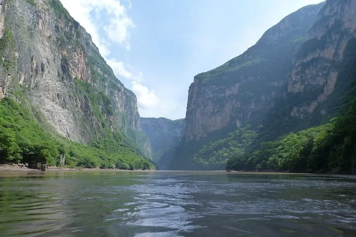 River flowing between the massive steep rock walls of Sumidero Canyon.
