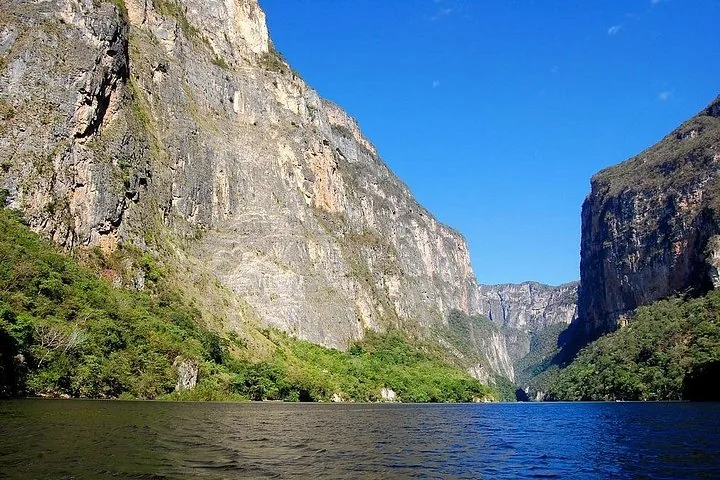 Wide view of the majestic Sumidero Canyon cliffs and flowing river.