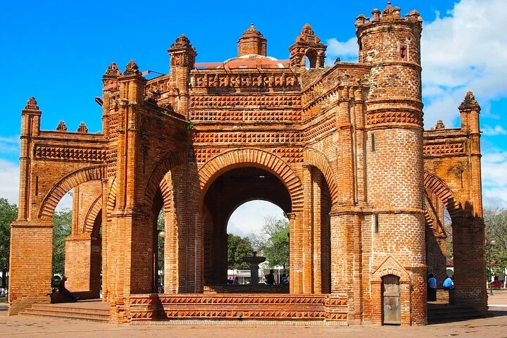 The ornate, red-brick La Pila fountain standing in a sunny plaza