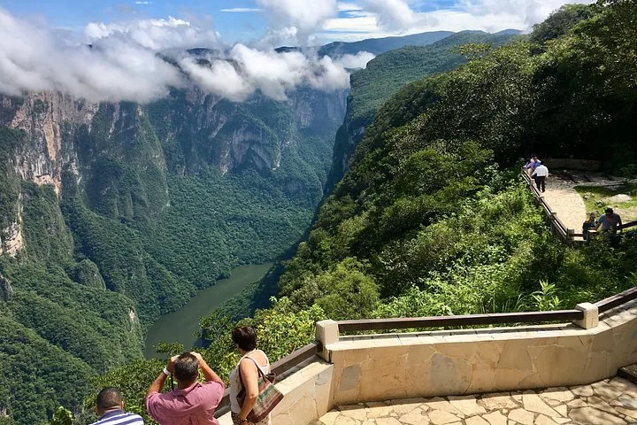 Tourists at a viewpoint overlooking the dramatic cliffs of Sumidero Canyon